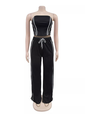 Black tube top and wide-leg pant set with white stripe detail and drawstring waist.
