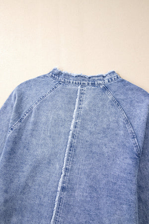 Acid wash denim shirtdress with raw hem neckline and frayed back seam detail.