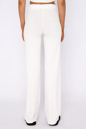 White ribbed wide leg pants with a high waist, shown from the back.