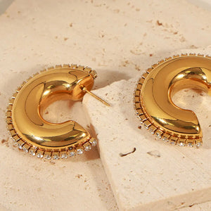 Gold cubic zirconia embellished crescent hoop earrings with a celestial design.