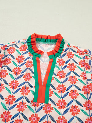 Floral ruffled v-neck shirt with striped trim and colorful floral pattern