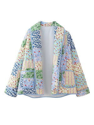 Floral quilted patchwork jacket with blue trim and pockets.