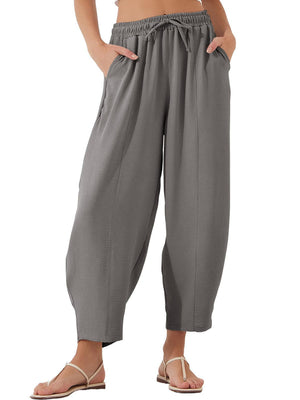 Gray balloon trousers with drawstring waist and sculpted seamline detail.