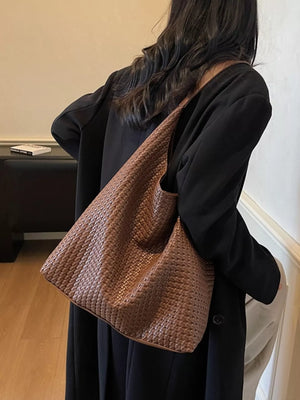 Brown woven straw texture tote bag with braided detail.