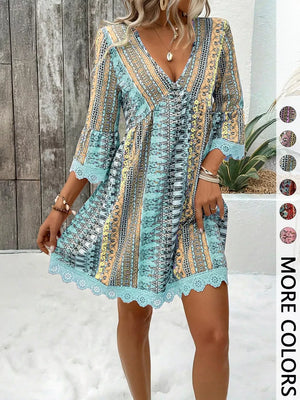Bohemian printed V-neck dress with bell sleeves and lace trim in blue.