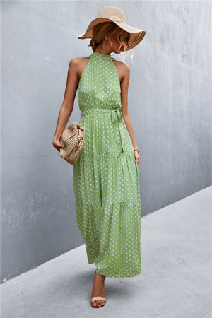 Green polka dot halter maxi dress with tiered skirt and tie waist