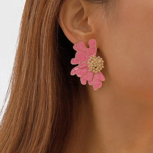 Pink textured flower stud earrings with gold center detail.