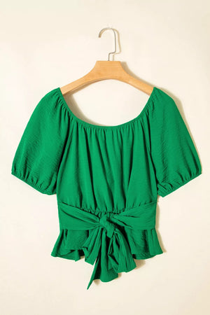 Green ruched crossed waist peplum shirt with puff sleeves and tie front.