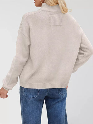 Ivory knit cardigan with ribbed detail on the back yoke and cuffs.