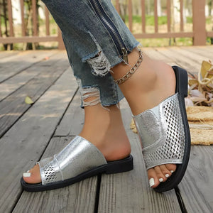 Chic silver hollow-out slide sandals with breathable perforated detail.
