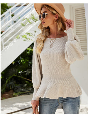 Cream ribbed knit peplum top with balloon sleeves and a scoop neck.
