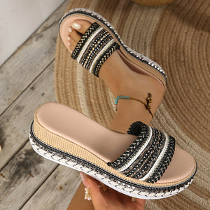 Black embellished open-toe platform sandals with beaded straps and espadrille trim.