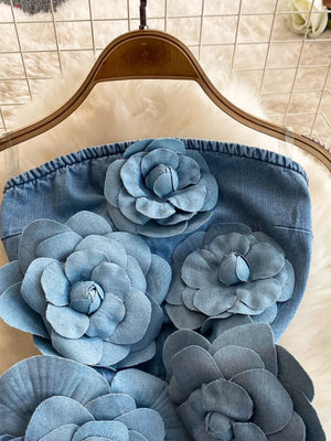 Strapless denim dress with 3D floral applique in blue.