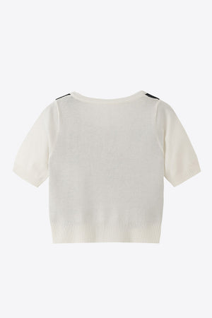 White argyle knit cropped cardigan with short sleeves and ribbed hem.