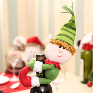 Festive bottle hugger with green elf character, red scarf, and striped hat.