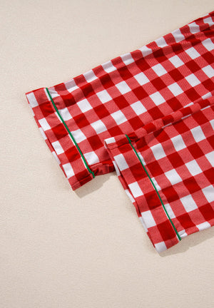 Festive red and white gingham pajama set with green trim detail.
