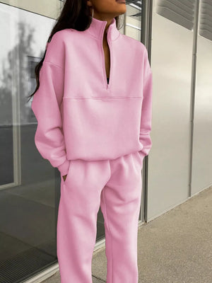Blush pink half zip sweatshirt and matching pants set with a funnel neck and relaxed fit.