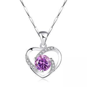 Silver heart pendant necklace with a lavender zircon and clear crystals.
