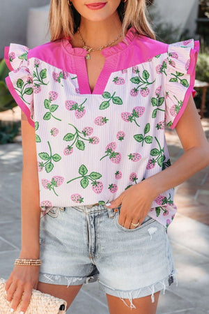Strawberry print cotton blend blouse with pink color block, flutter sleeves, and ruffled neckline.