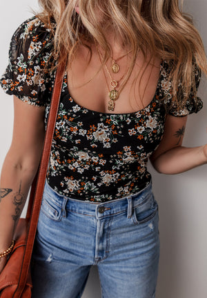 Black floral puff sleeve bodysuit with a scoop neck