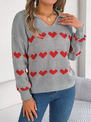 Gray knit polo sweater with red heart stripe pattern and collared neckline.