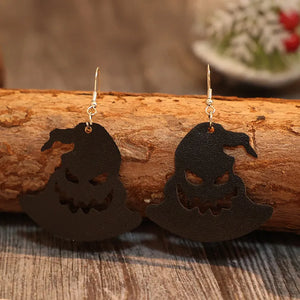 Black leather witch hat earrings with carved jack-o-lantern faces.