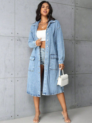 Denim duster coat in medium wash with long sleeves, collared neckline, button front, and utility pockets.