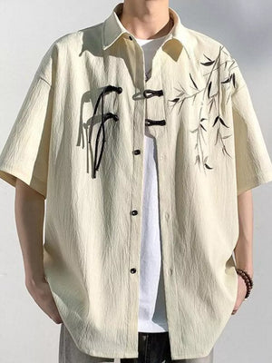 Men's relaxed fit short sleeve shirt in tan with bamboo print and frog button closure.