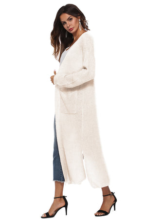 Longline ivory knit cardigan with pockets and side slits.