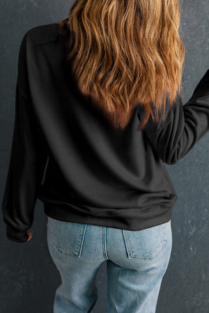 Black crewneck sweatshirt with rhinestone wink-star smiley graphic on back.