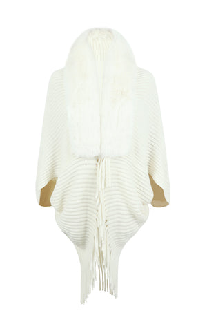 Ivory knit cape with faux fur collar and fringe detail.