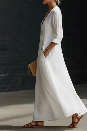 White buttoned maxi dress with V-neck, 3/4 sleeves, and pockets.