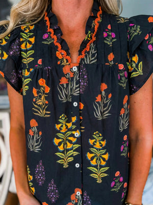 Black floral print maternity shirt with V-neck, button front, and orange frill detail.