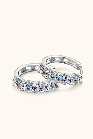 Silver pavé crystal huggie earrings with five round-cut stones each.