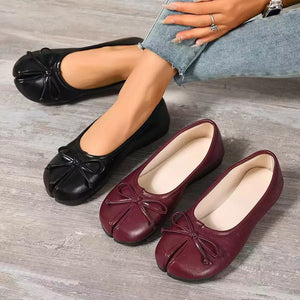 Elegant bow-embellished tabi slip-on flats in black and burgundy.