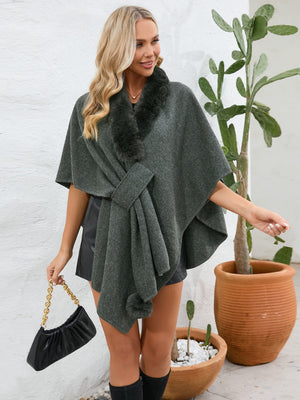 Gray faux fur collar wrap poncho with tie detail and pom-pom trim.