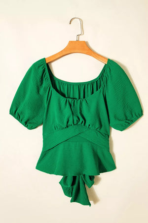 Green ruched peplum shirt with square neckline, puff sleeves, and crossed waist detail.