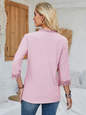 Blush pink eyelet blouse with lace trim on collar and sleeves.