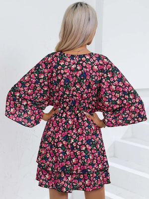 Black floral mini dress with ruffle hem and bell sleeves.