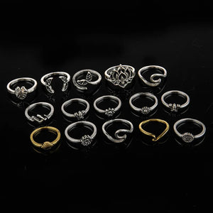 Silver botanical & sculptural ring stack with leaf, lotus, and abstract designs.