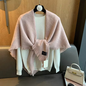 Luxurious fuzzy triangle shawl scarf in dusty pink with fringe detail, styled over a white sweater.