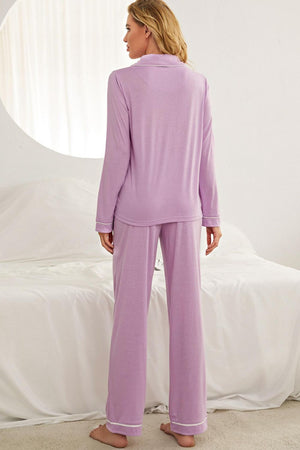 Purple pajama set with contrast piping, long sleeves, collared neckline, and wide-leg pants.