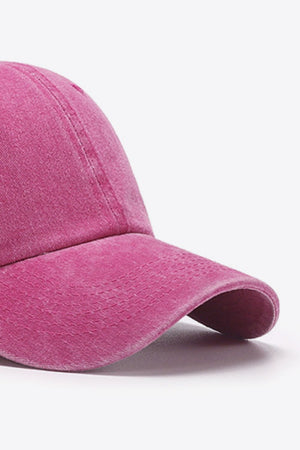 Washed cotton baseball cap in magenta with stitched details and curved brim.