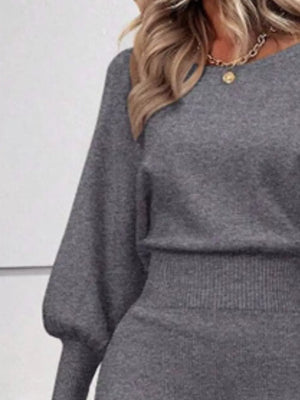 Grey acrylic bodycon sweater dress with dramatic lantern sleeves and ribbed waist detail.