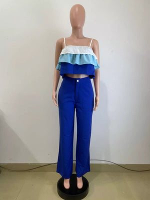 Chic layered ruffle crop top set in blue with white and light blue tiers, paired with wide-leg pants.