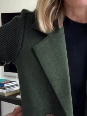 Double-breasted trench coat in dark green with ribbed knit sleeves and notched lapel.