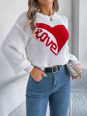 White knit sweater with red heart graphic and "love" text, crewneck, long sleeves.
