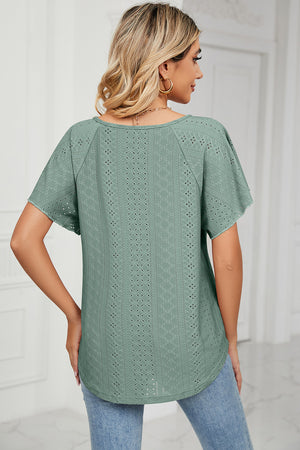 Light green eyelet blouse with flutter sleeves and a scoop neck.