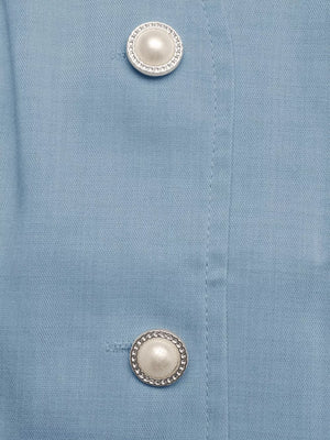 Blue buttoned vest detail with pearl and chain buttons