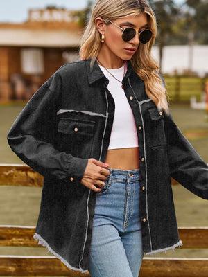 Black frayed edge overshirt with patch pockets and button front, styled with a white crop top and jeans.